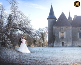   Early in the morning in Liorac/Louyre, Dordogne, the couple braves the winter chill together, bundled close for warmth while sharing affectionate glances in the quiet countryside.